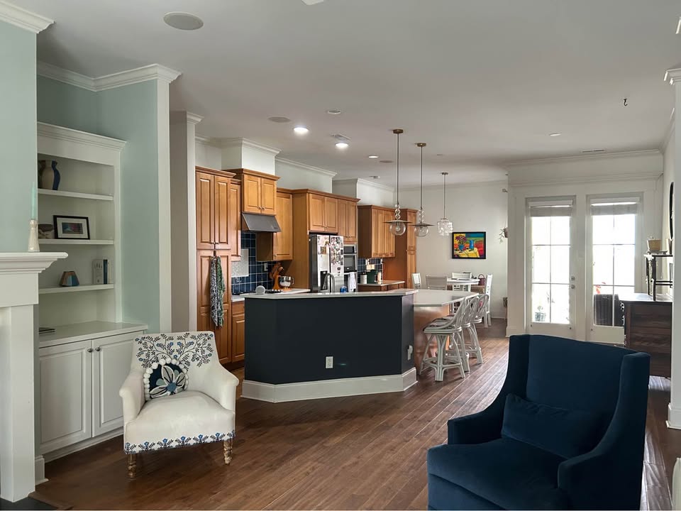 Open living room with built-ins and navy blue kitchen island